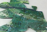 A sheet of fabric showing pieces already cut out to make jewellery